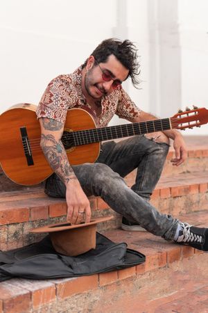 Latin Musician collecting money after performance on street
