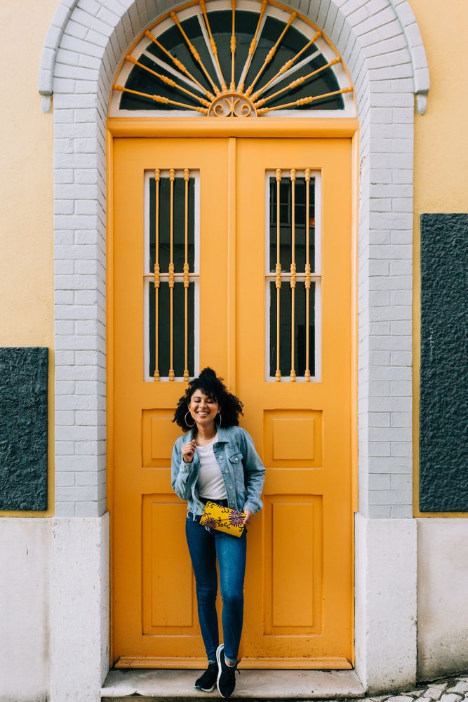 Stylish female by yellow door