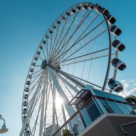 Worm view of Ferris wheel under blue sky in Miami, Florida, United States 