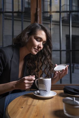 Young female with tea cup in cafe