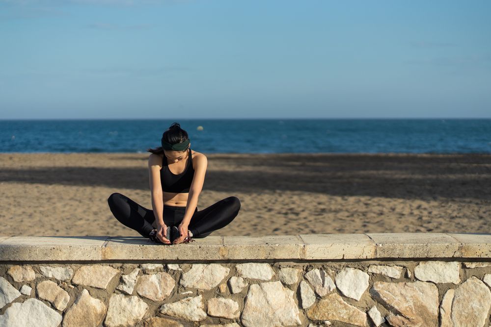 Woman stretching at seaside