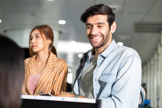 Couple checking in for flight at airport