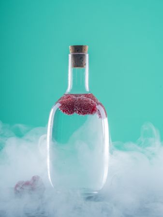Bottle with drink between fog