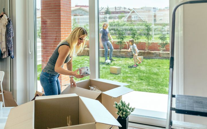 Woman unpacking moving boxes