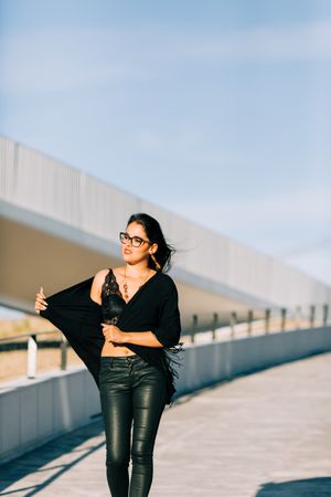 Trendy female standing on urban background
