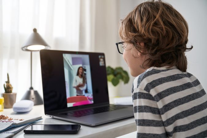 Boy video chatting with classmate