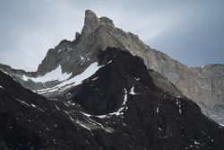 Mountain peak abutting sky in desert valley