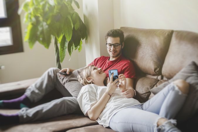 Couple with gamepads playing console