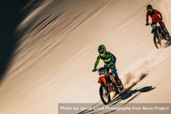 Motocross bike rider over sand dunes 5knDD0