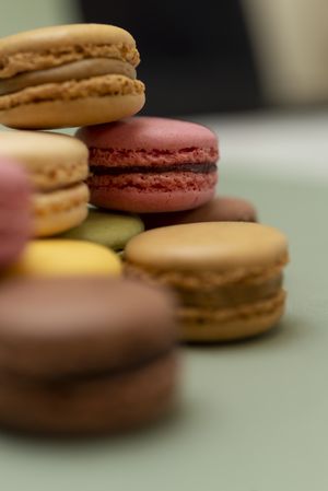 Pile of tasty French macaroon on a green table