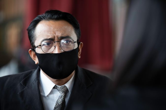 Concerned Asian business man wearing protective face mask