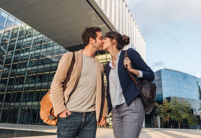 Businesspeople couple outside contemporary building