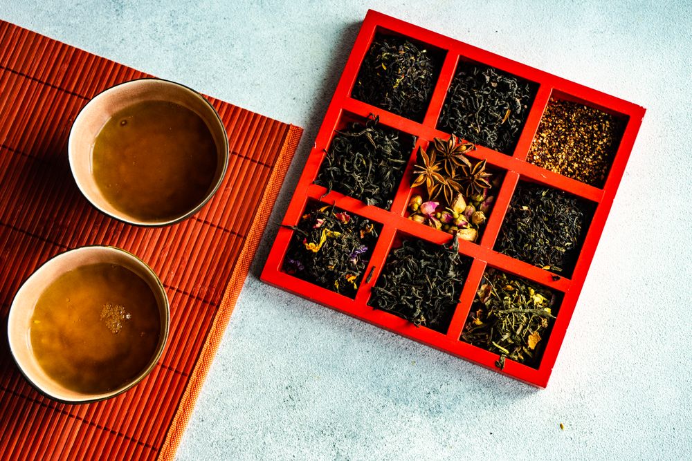Cup of green tea with box of loose leaf options