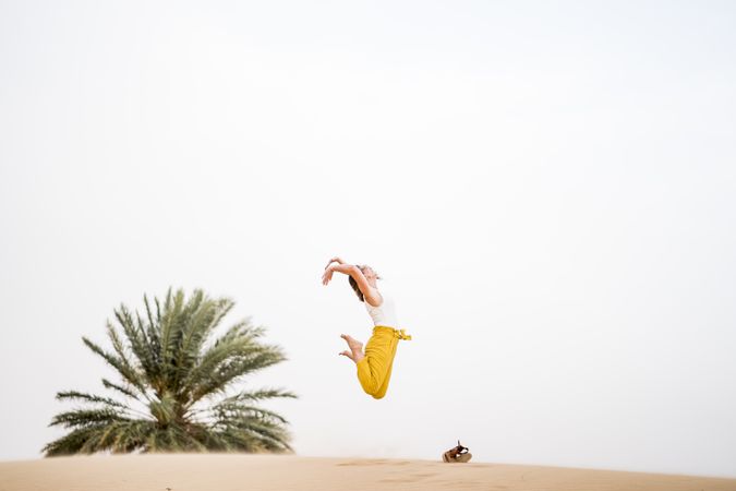 Happy woman jumping in desert