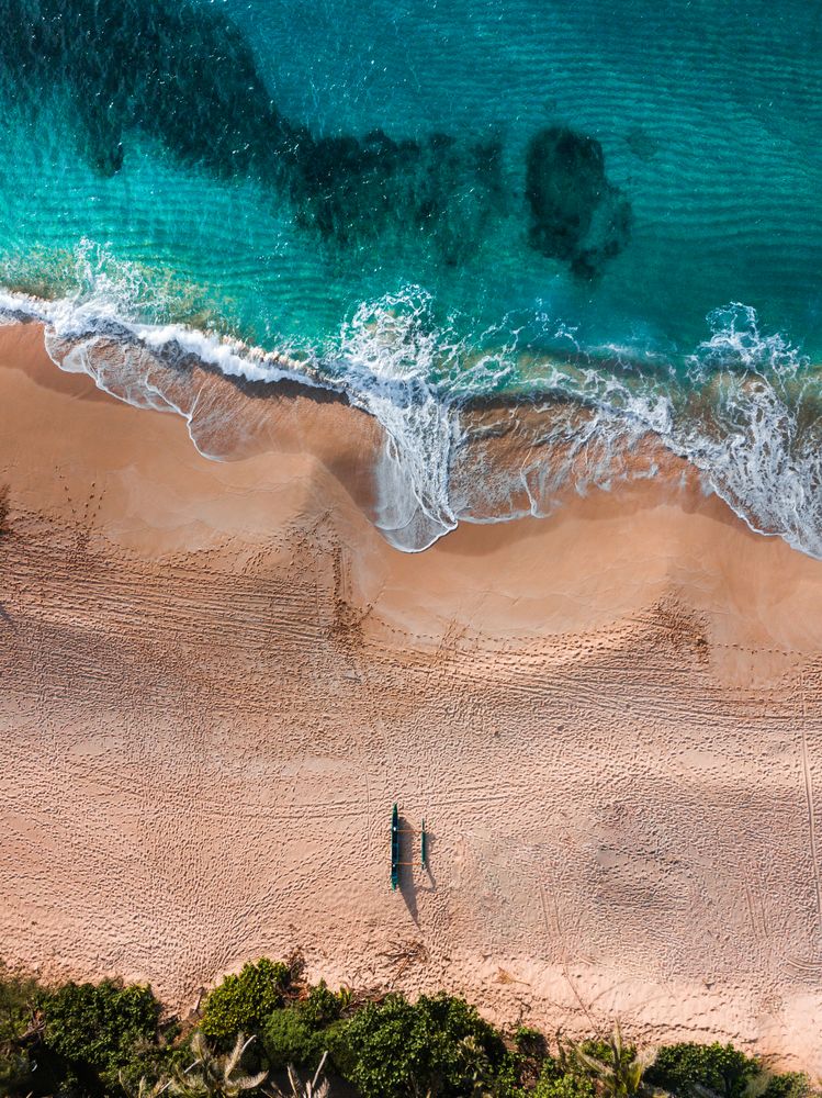 Aerial view of waves on sandy shore