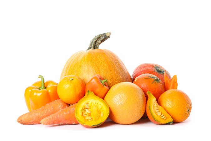 Pumpkins, oranges, carrot and peppers isolated on plain background