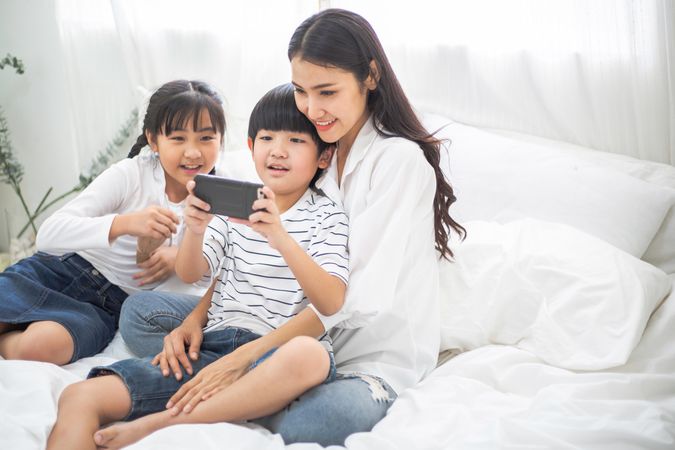 Happy family watching movie on smartphone