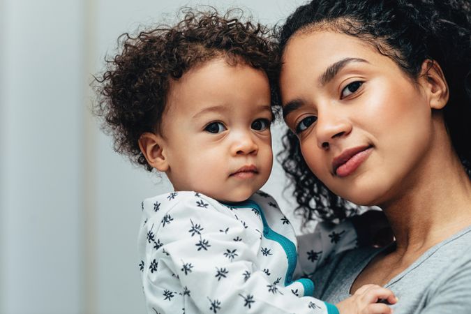 Portrait of beautiful mother with son in living room