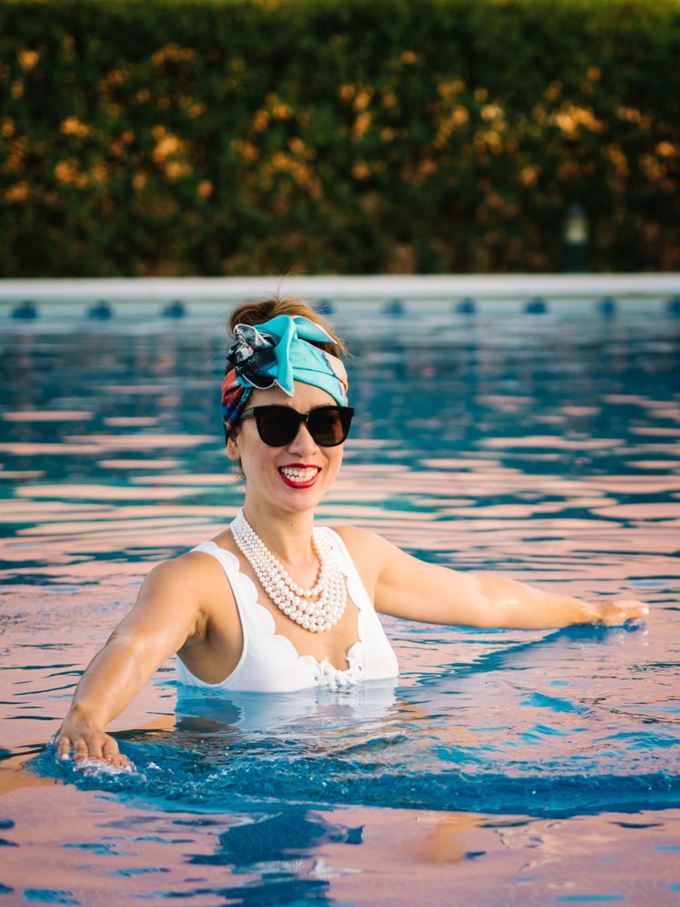 Young elegant Chinese woman relaxing inside a pool