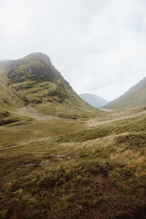 Green valley by high rocks