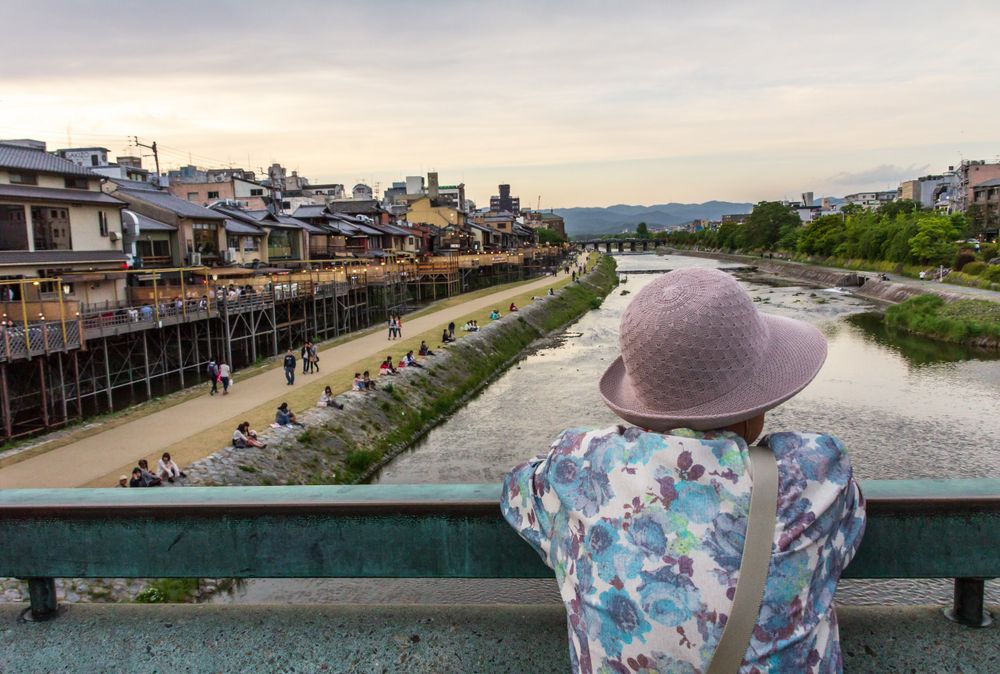 Japan - May, 10 2013: Anonymous person looking at river and town