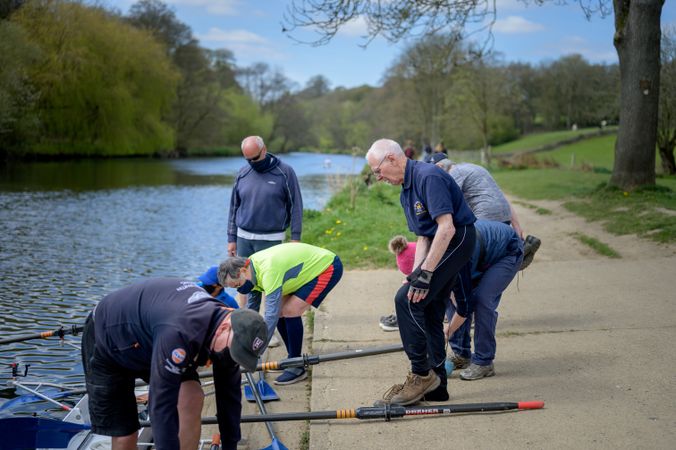 Group of older men getting ready to get into boat to row