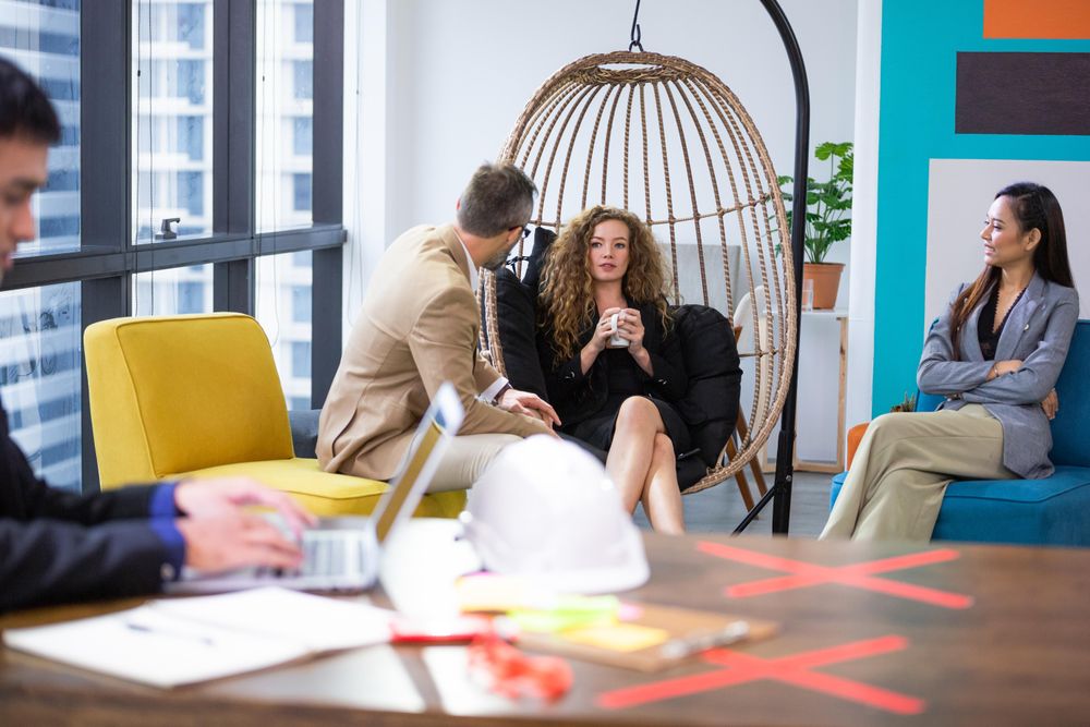 Group of diverse people discussing at couch in the office