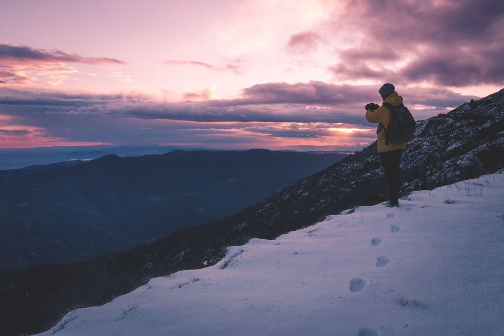 Anonymous tourist on snowy mountain