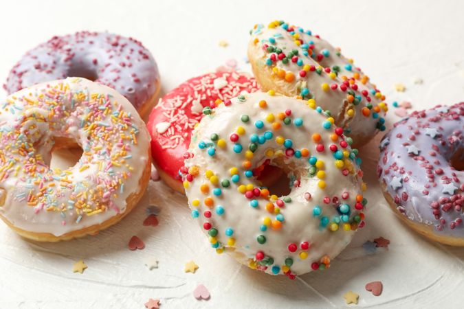 Tasty donuts on plain background, close up