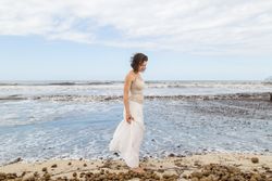 Charming young woman on shore near water