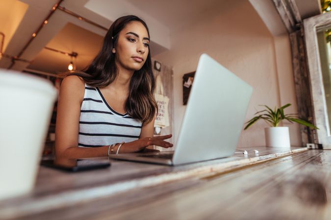 Woman blogger working on laptop at home