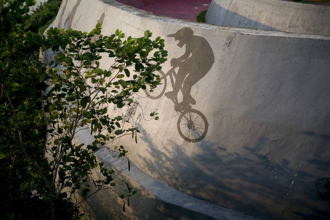 Shadow of person on bike on wall