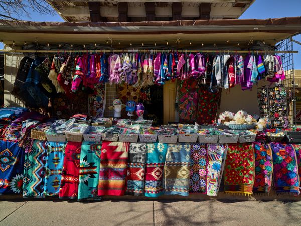 An array of colorful rugs and clothing items outside the Crazy Horse gift shop in Santa Fe