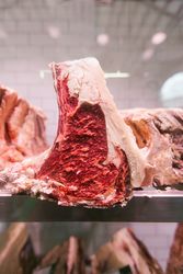 Raw meat on a butcher's chiller for maturing