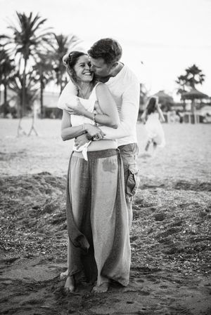Happy kissing couple on beach