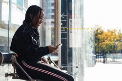 Happy female on bus stop