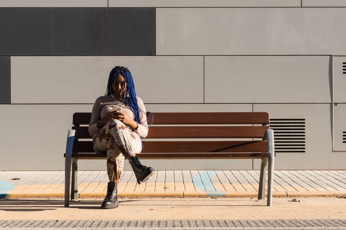Serene Black woman in earphones on street