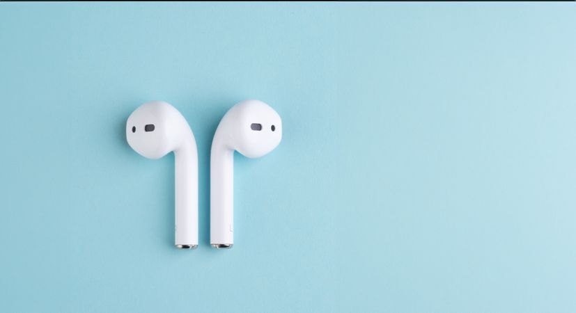 Minimalist earbuds on turquoise background