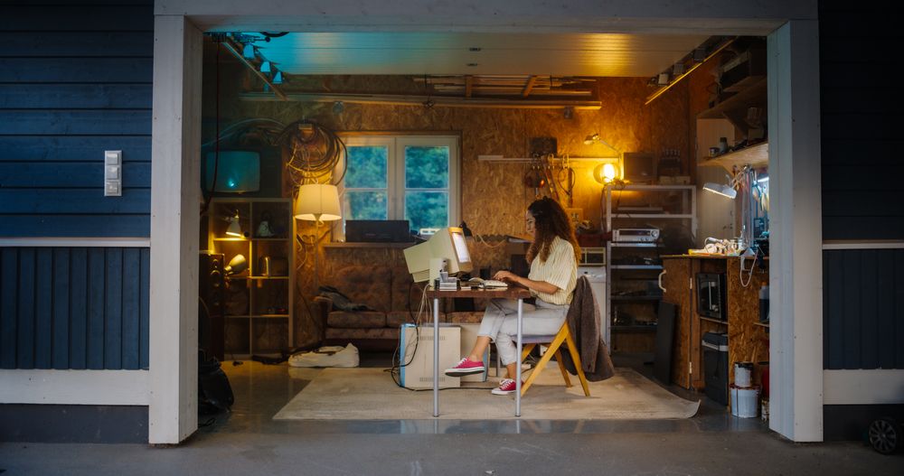 Hispanic Female Software Developer Programming On Old Desktop Computer In Retro Garage In the Evening.