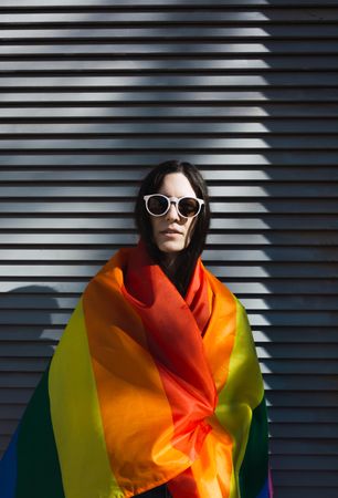 Woman posing happily with the LGBT flag