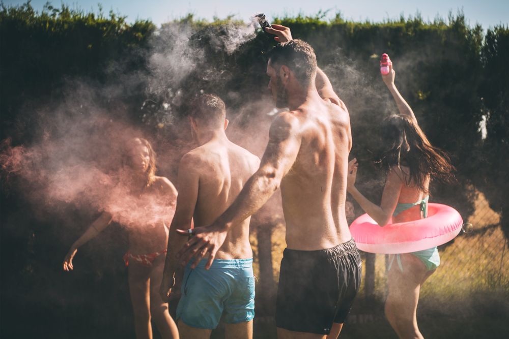 Friends lighting smoke torch