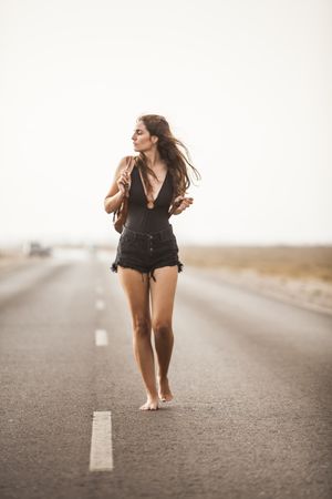 Smiling woman walking on road