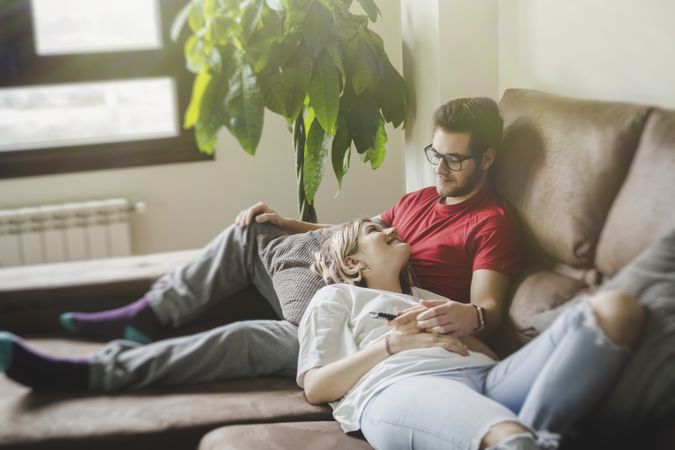 Couple with gamepads playing console