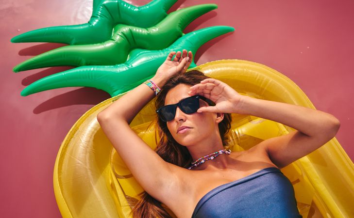 Dreamy female resting on inflatable mattress