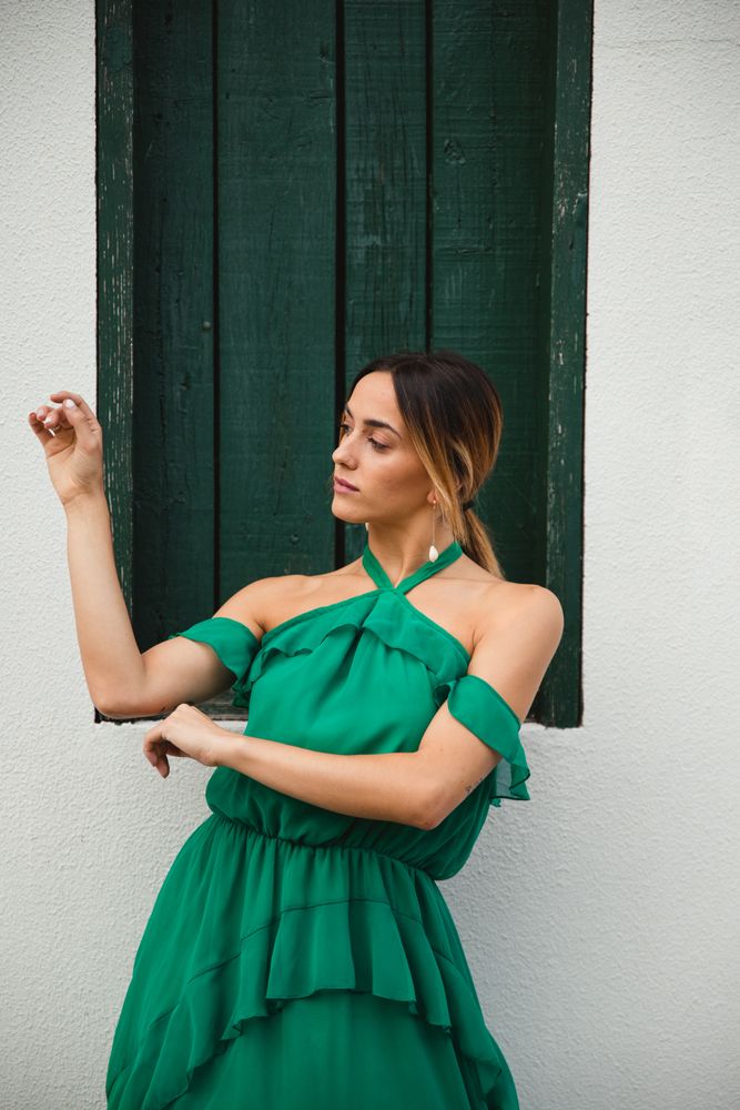 Barefoot woman leaning on house wall