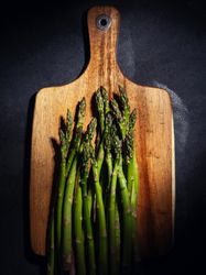 Asparagus on wooden cutting board