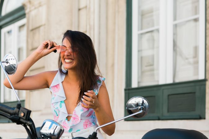Woman looking at motorcycle mirror