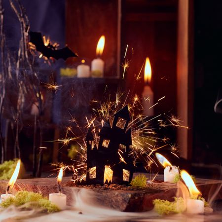 Creative Halloween composition with firework and candles