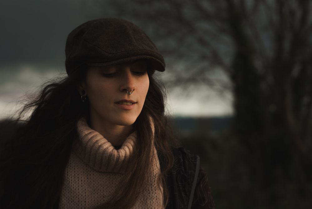 Young woman in warm clothes in forest