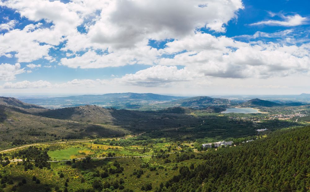 Breathtaking white clouds above hills with greenery